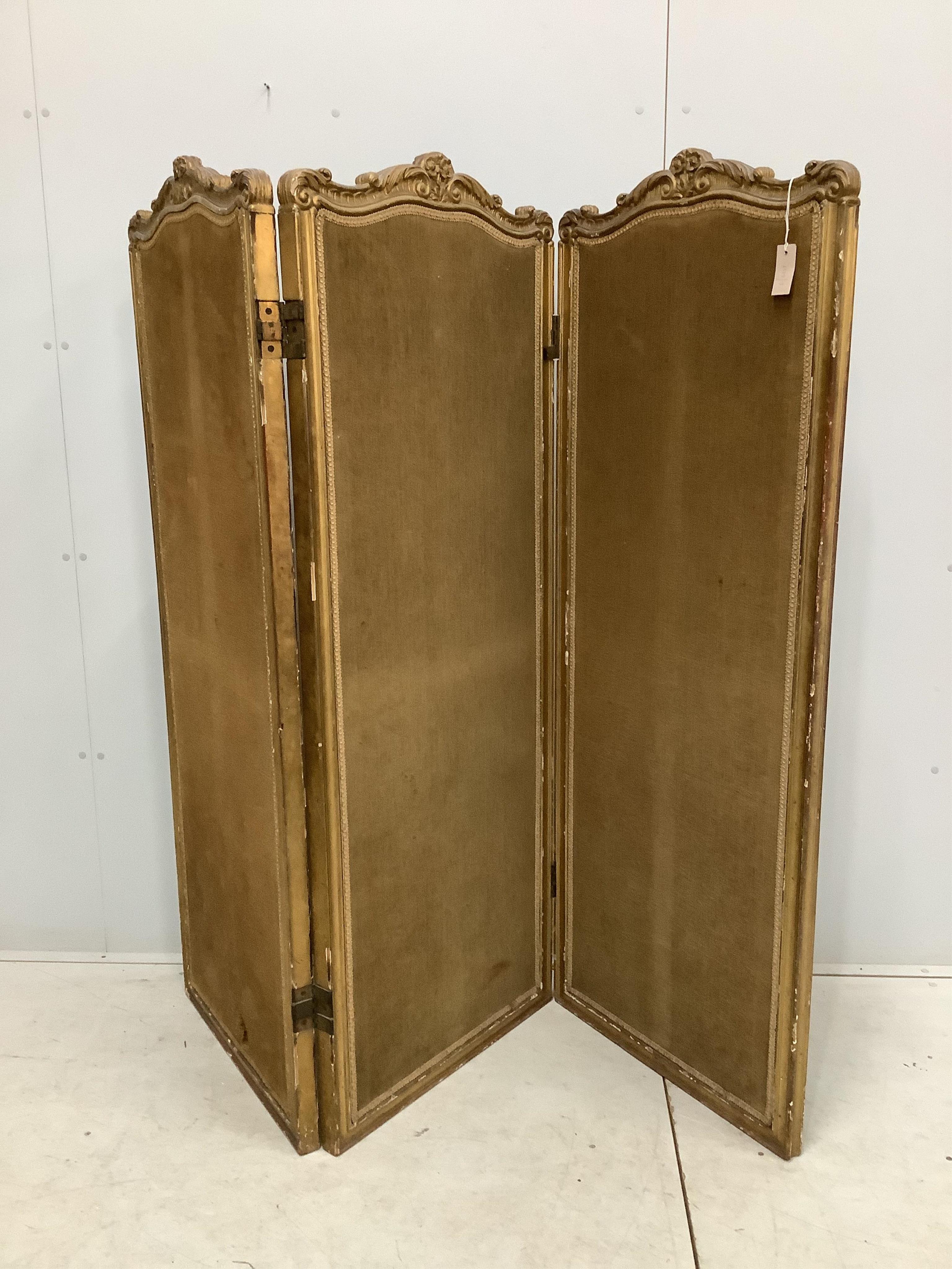 A Victorian style folding giltwood and composition three fold dressing screen, each panel width 62cm, height 162cm. Condition - fair